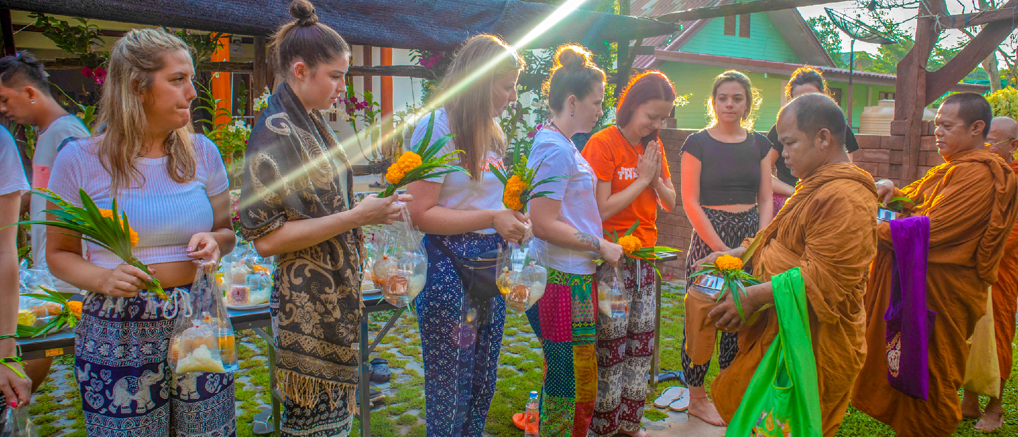 Backpacking group participating in a water fight with colorful water guns during a local festival