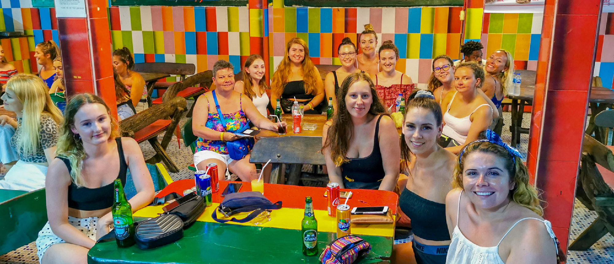 Backpacking group enjoying a meal at a colorful local restaurant on Koh Phi Phi