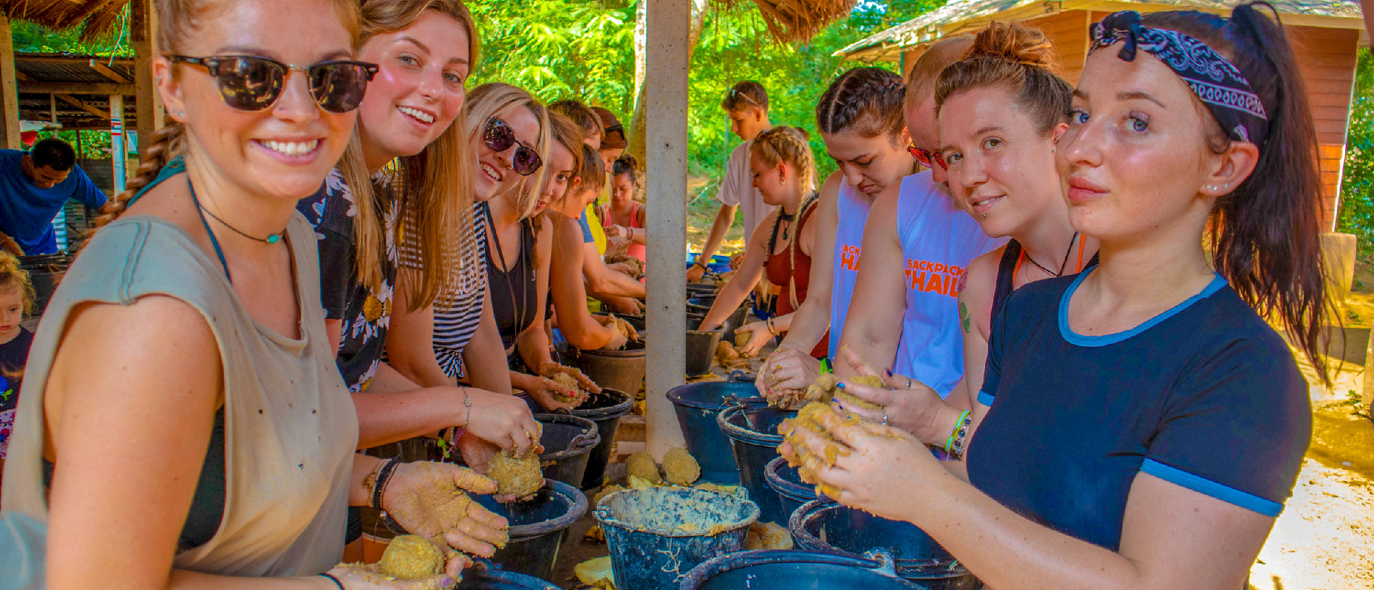Backpacking group enjoying lunch at a rustic outdoor pavilion at the elephant sanctuary