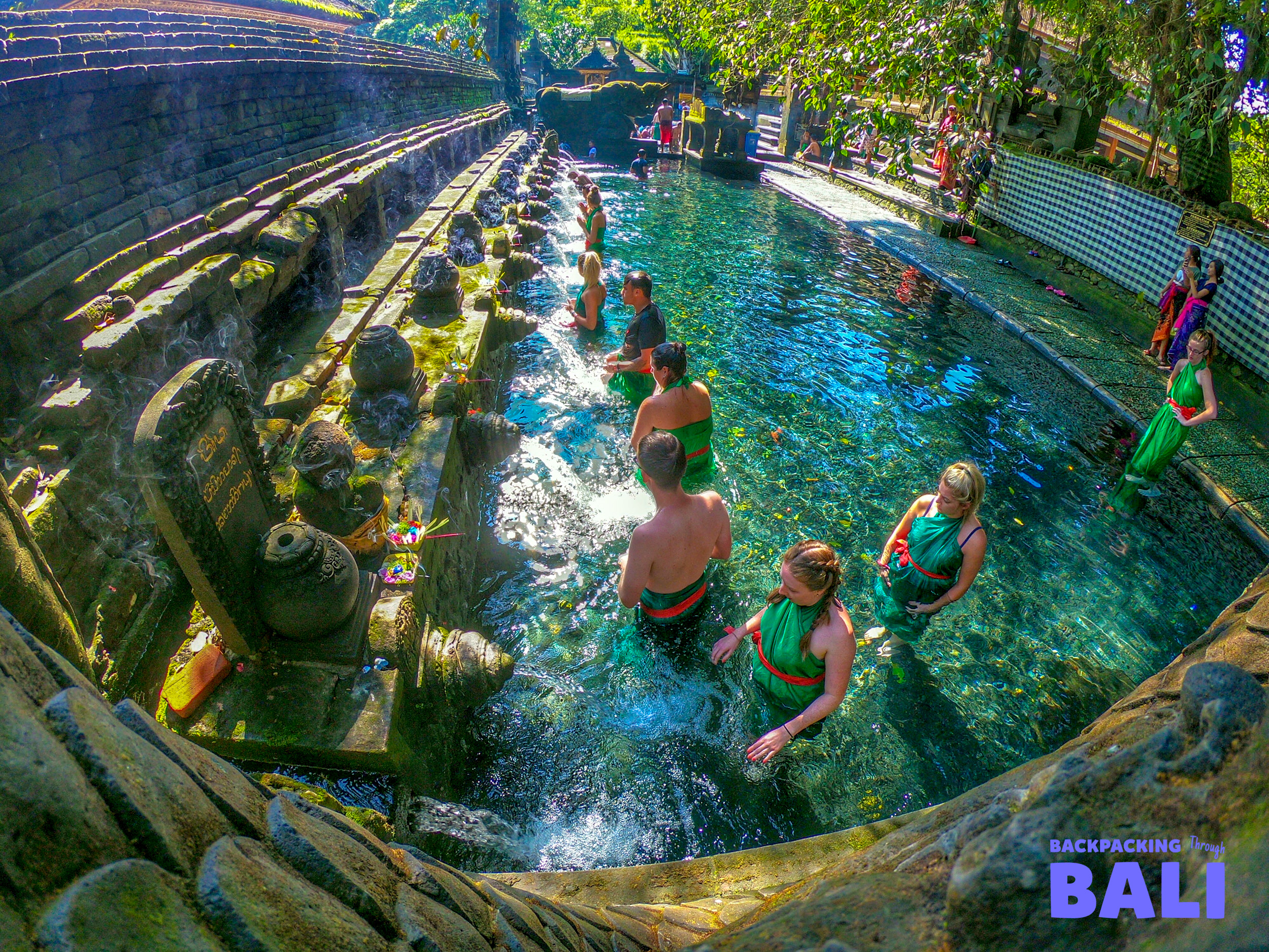 Aerial view of travellers in a circular spring pool at a water garden