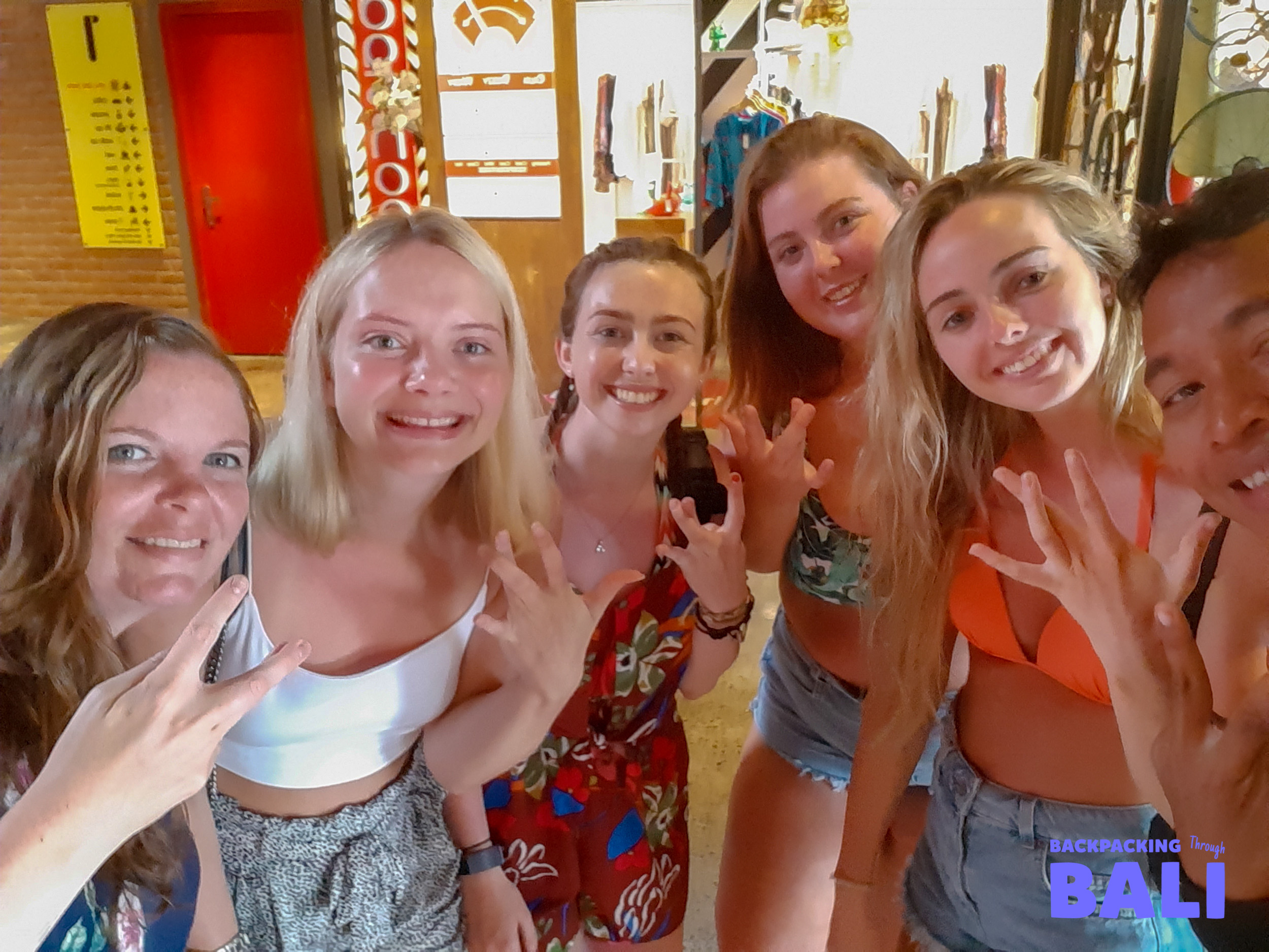 Group of female travellers smiling and posing indoors