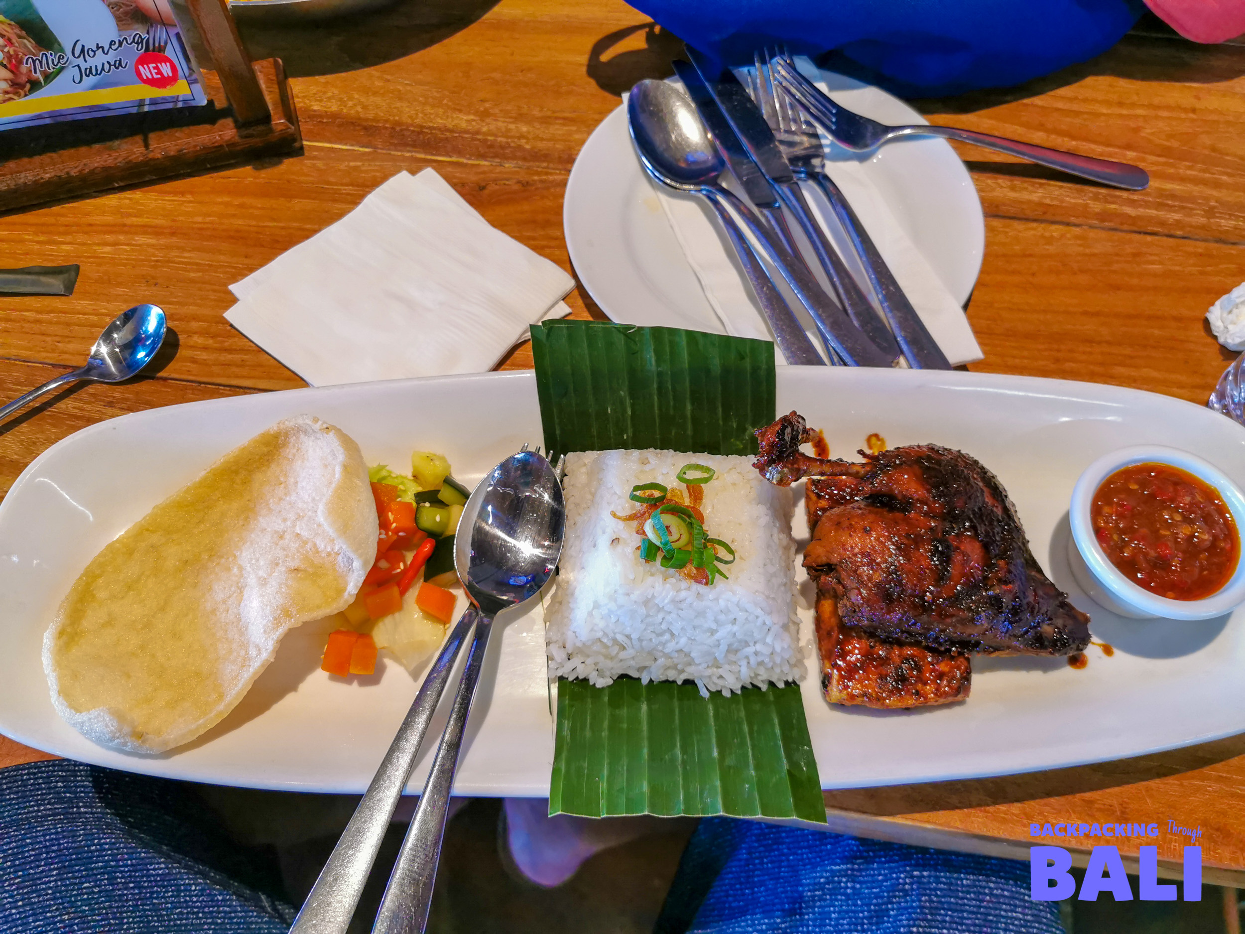 Traditional Balinese meal with rice, satay skewers and side dishes