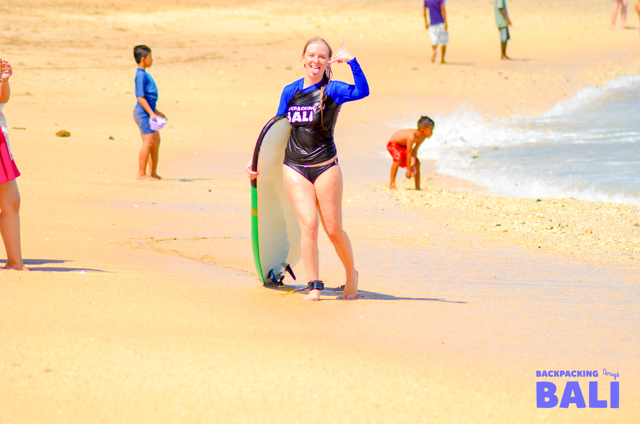 Backpacking couple having fun with a piggyback ride on the beach in Bali