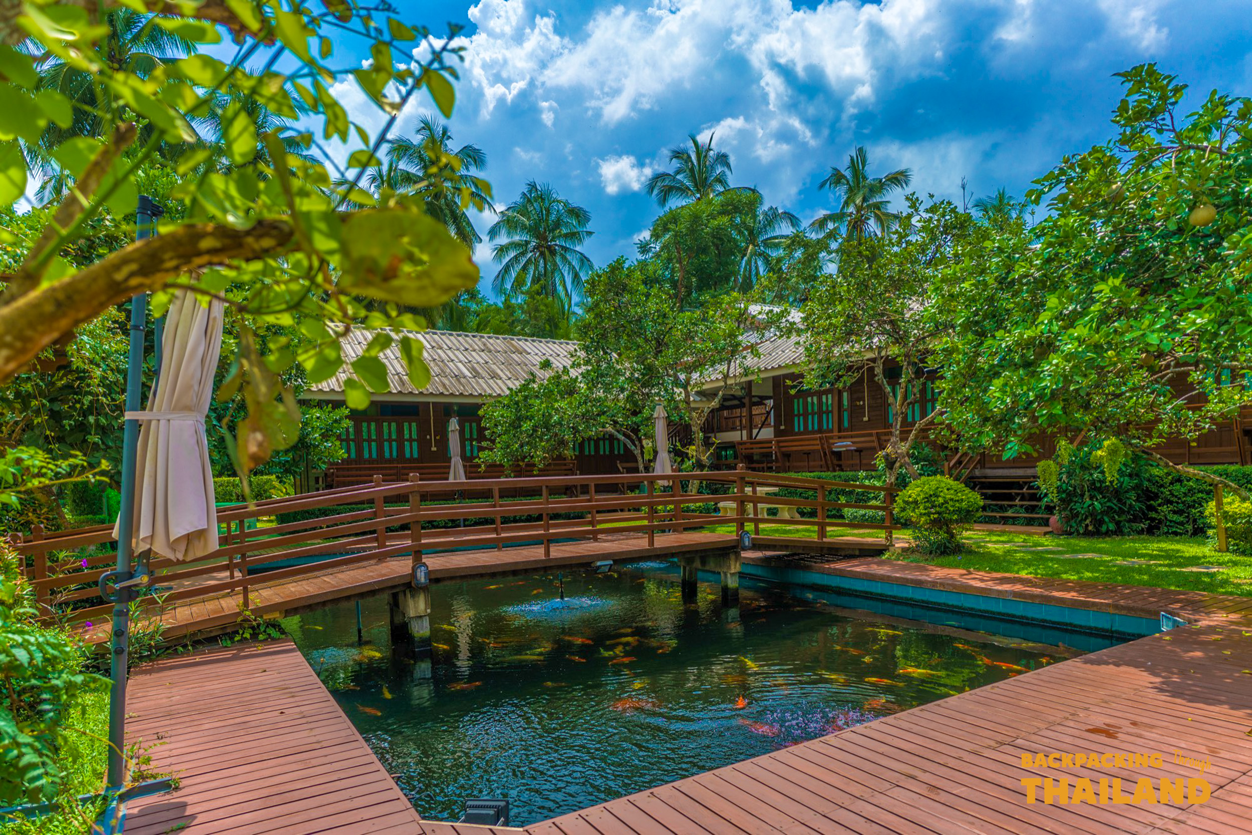 Riverside cottage overlooking a pond and brick pathway, Day 6 accommodation.