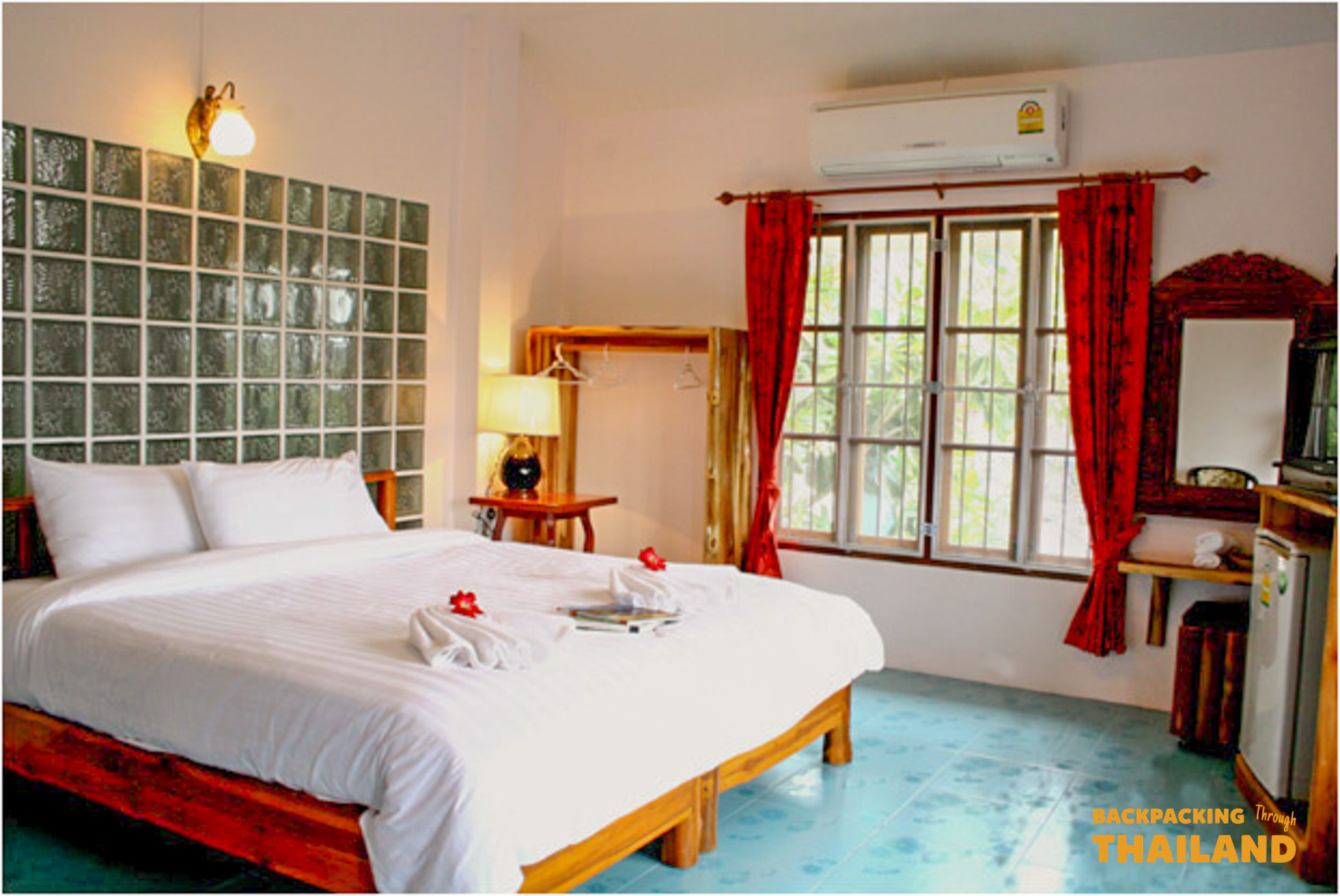 Modern hotel room with comfortable bed and wooden furniture