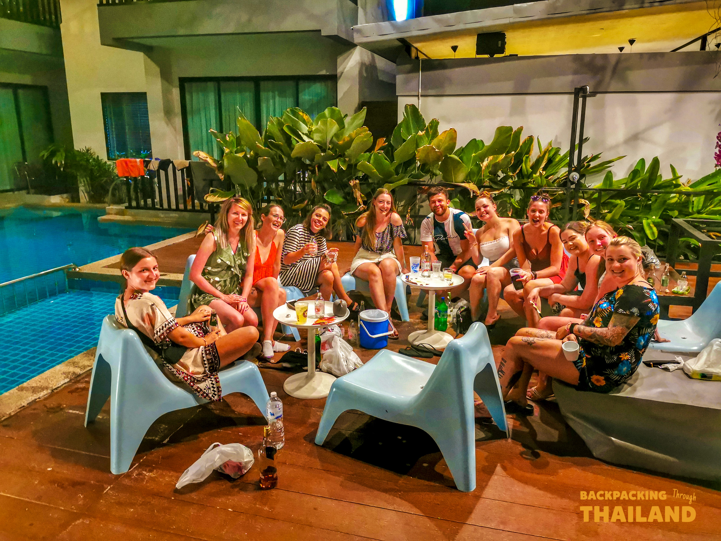 Large group of travellers dining together at a long table with colourful chairs, Day 9 activityFriends with neon paint and bright clothing smiling together at a night party, Day 9 activityNight party group with neon paint, Day 9 activityNight party group, Day 9 activity