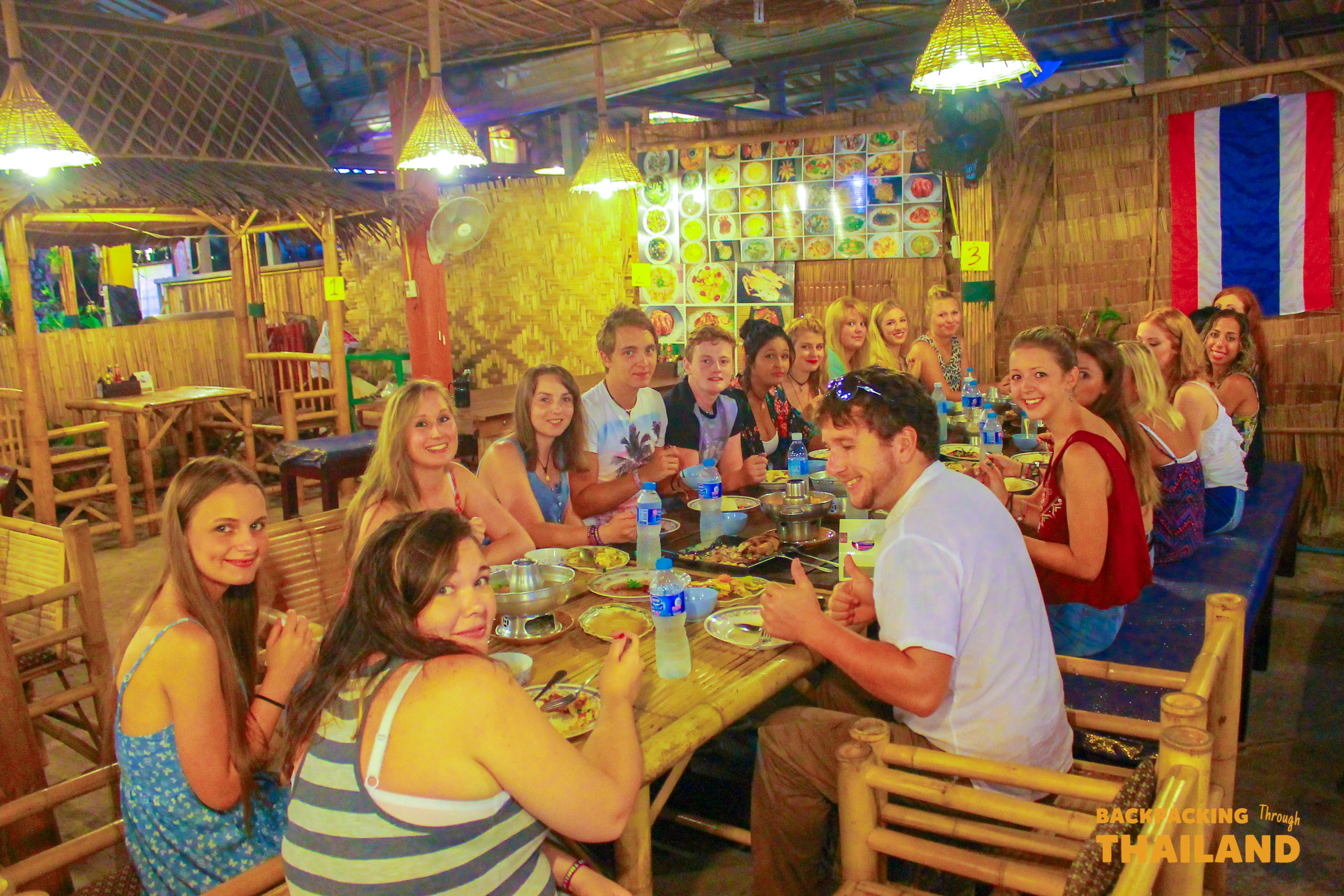 Group of travellers enjoying a meal together at a lively local restaurant, Day 9 activity