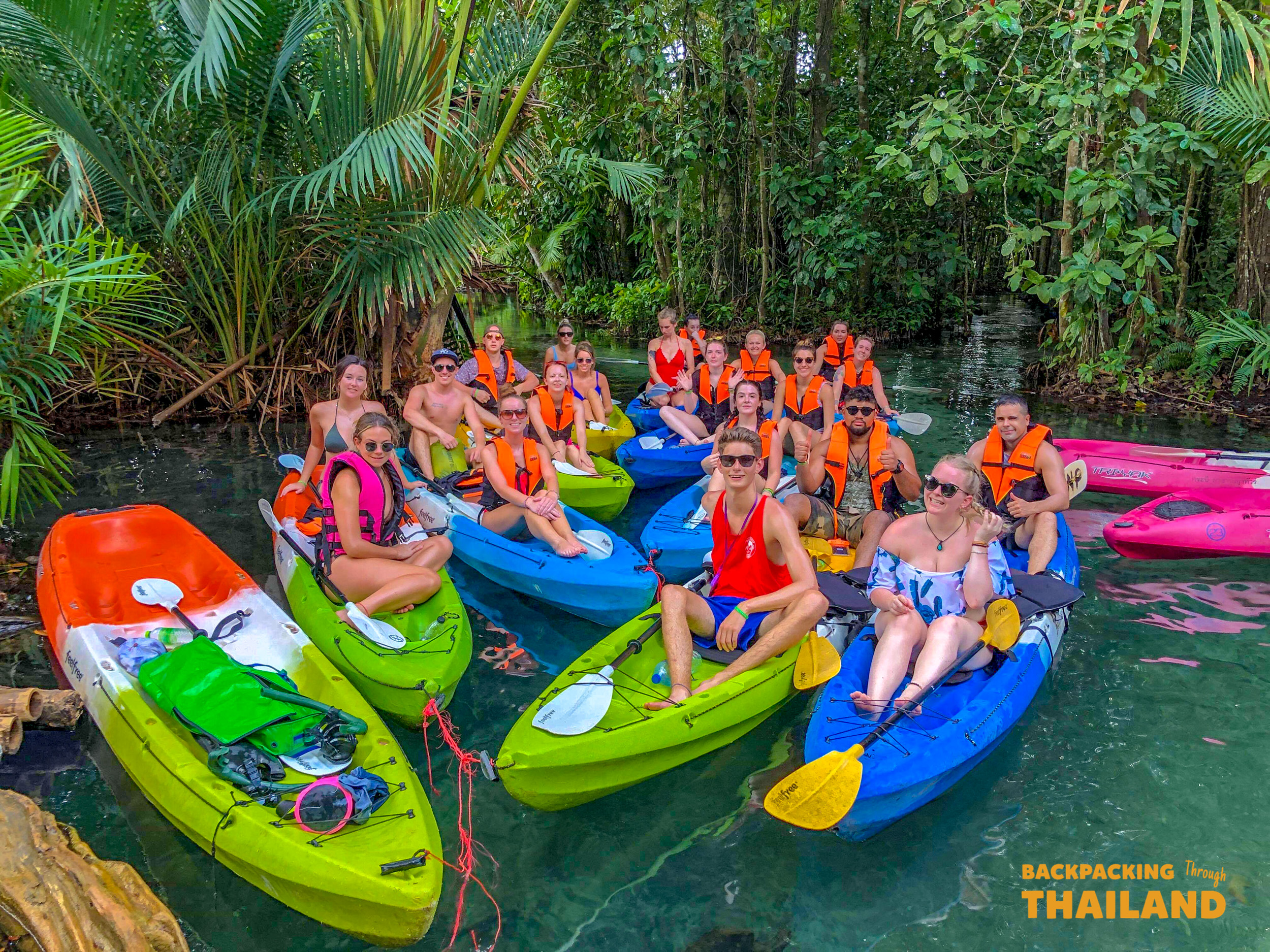 Travellers kayaking in colorful kayaks on an emerald lake, Day 10 activity