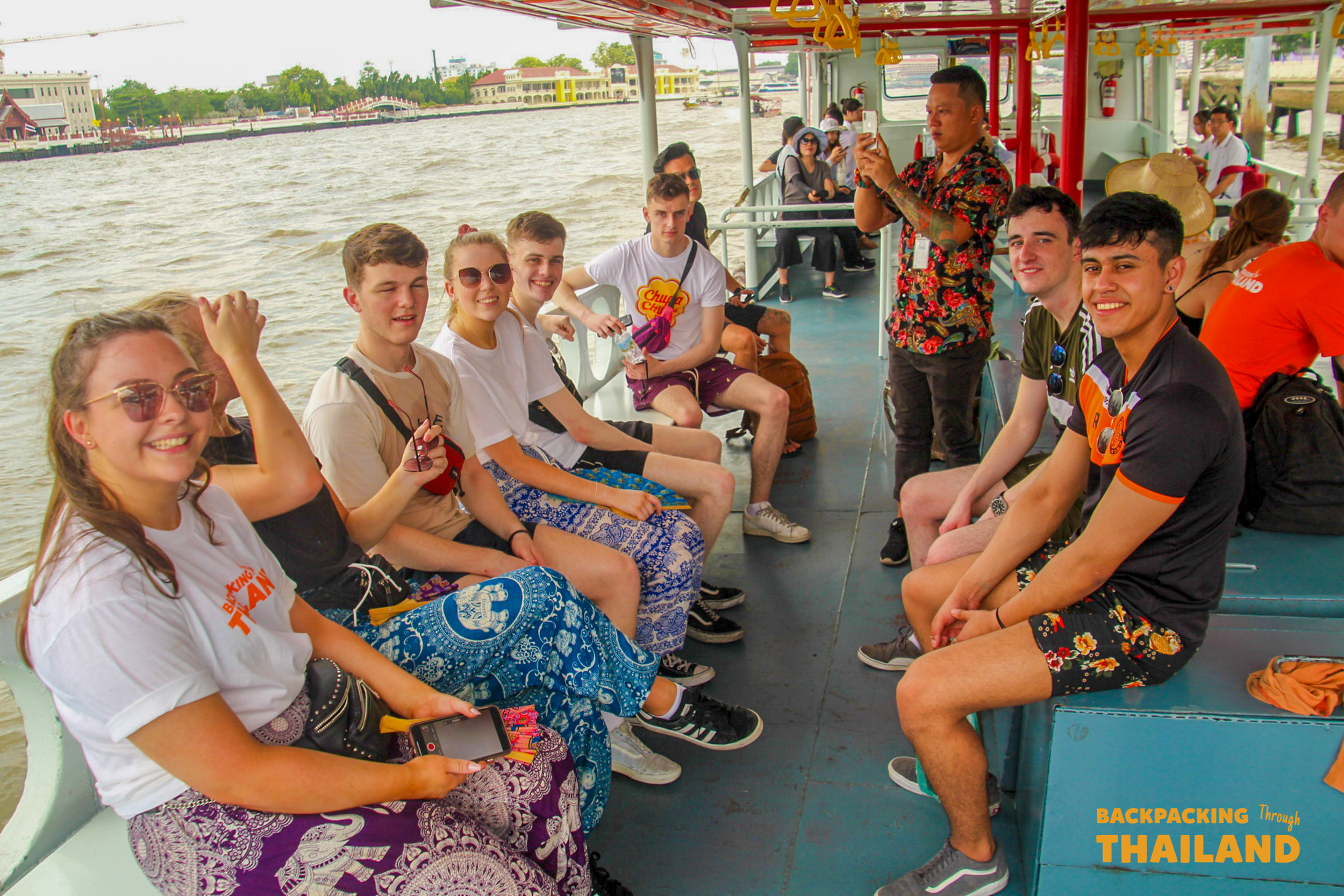 Scenic boat ride on Bangkok’s Chao Phraya River heading towards the iconic temple of Wat Arun.