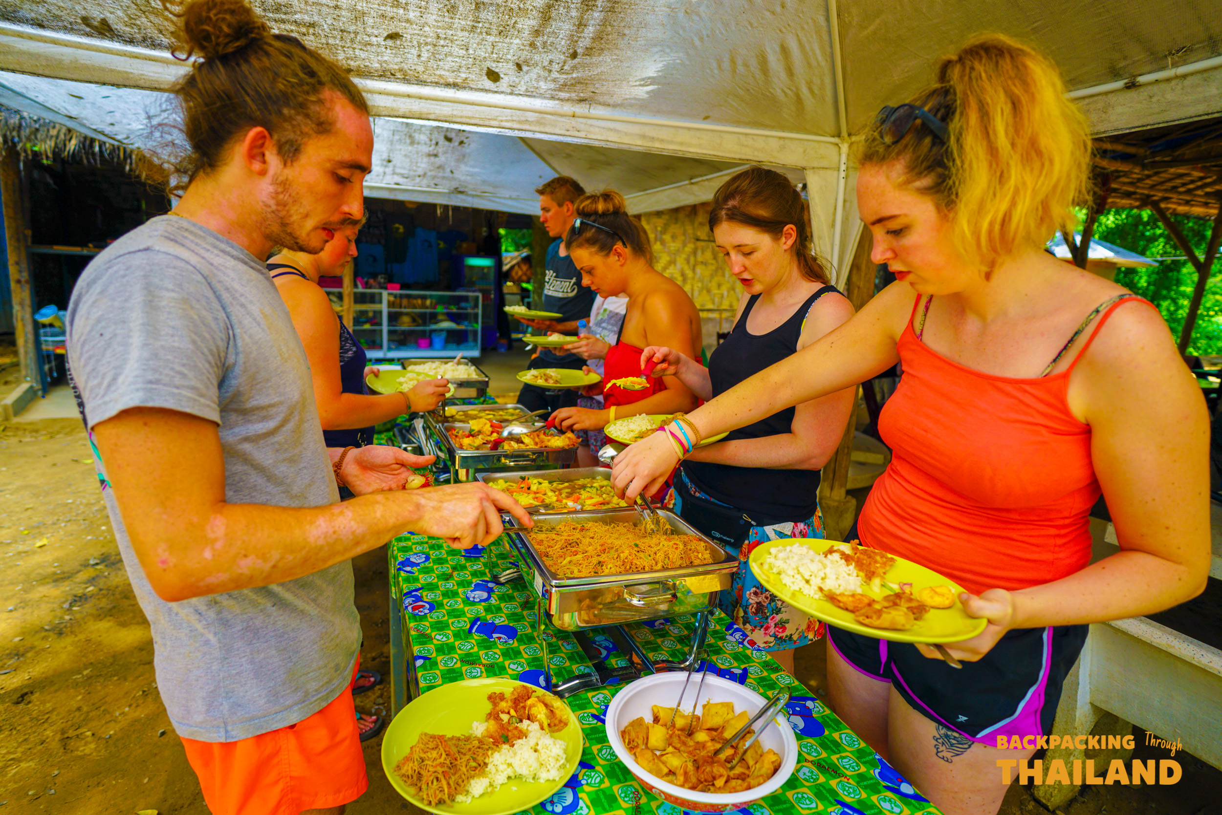 Backpacking group enjoying lunch at a rustic outdoor pavilion at the elephant sanctuary