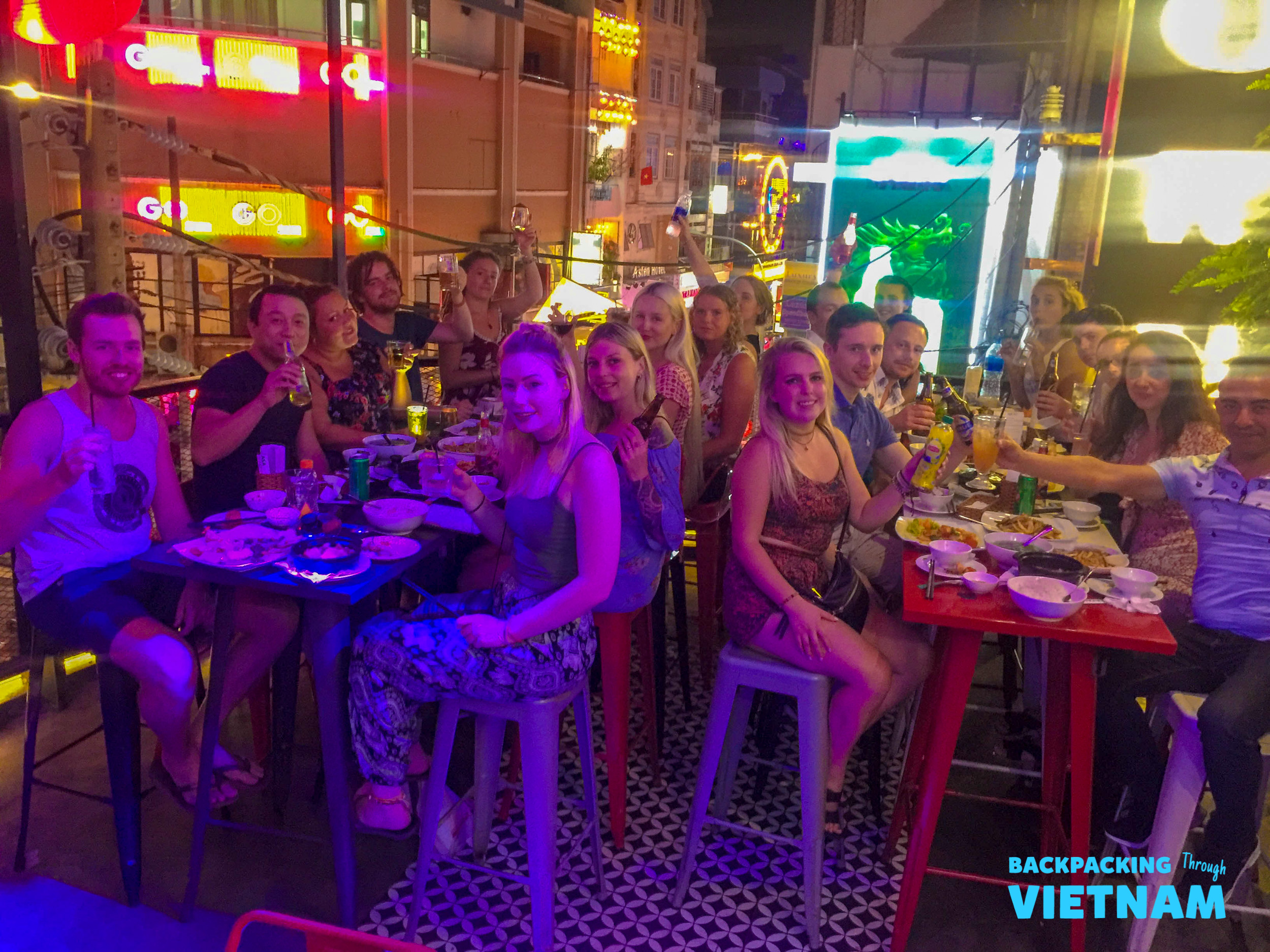 Backpacking group enjoying drinks in Saigon bar