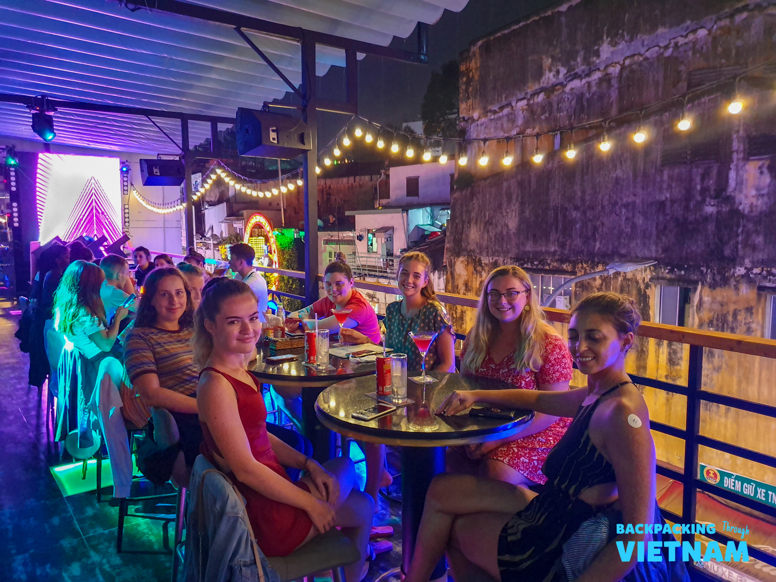 Backpackers enjoying drinks at a Saigon bar