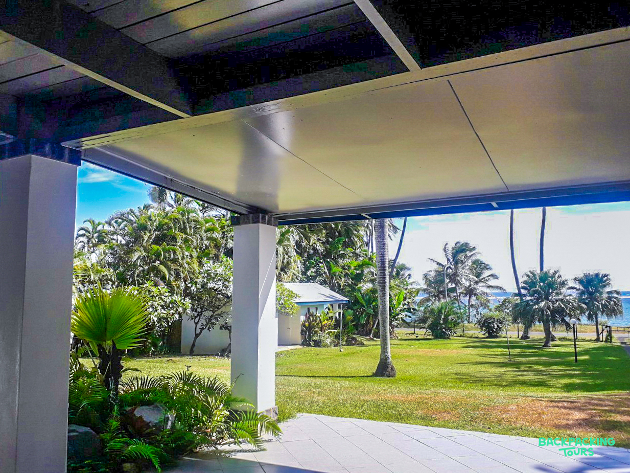 Enjoy a tranquil view from your accommodation, featuring a tropical garden, palm trees, and the ocean.