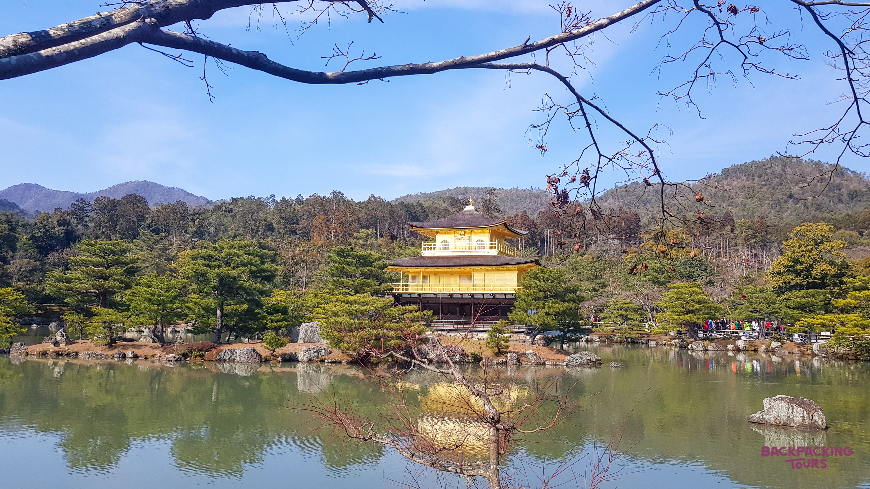 Golden Pavilion in Kyoto, Japan, reflected in the calm waters of its surrounding lake.