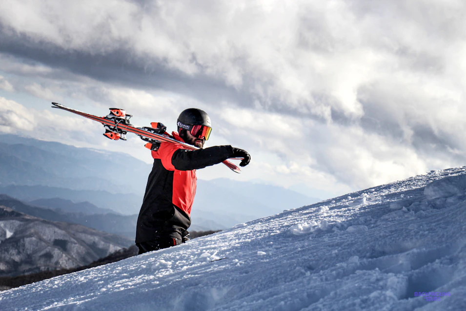 Snowboarder enjoying fresh powder on the slopes of Hakuba