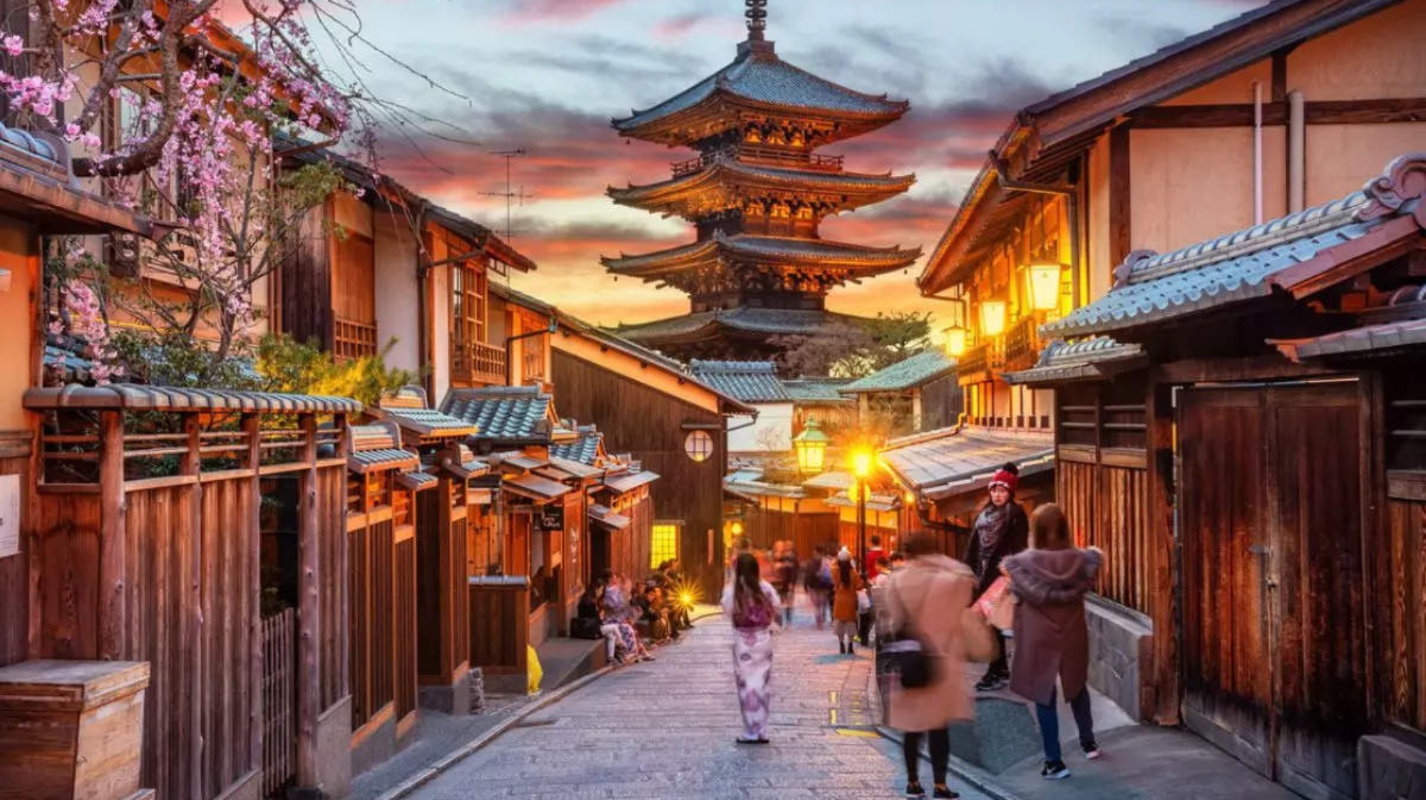 Traditional Japanese street lined with lanterns and wooden facades at dusk