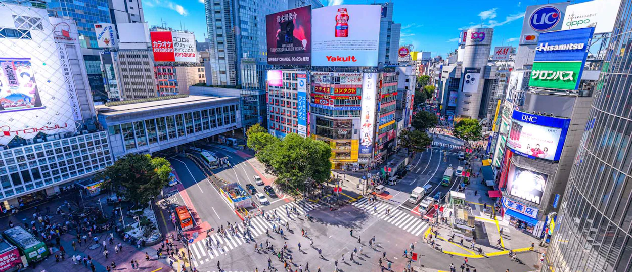 Hundreds of pedestrians navigate the famous Shibuya Scramble Crossing in vibrant Tokyo.