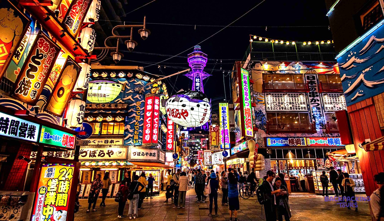 Neon signs and lanterns lighting up the retro Shinsekai district of Osaka