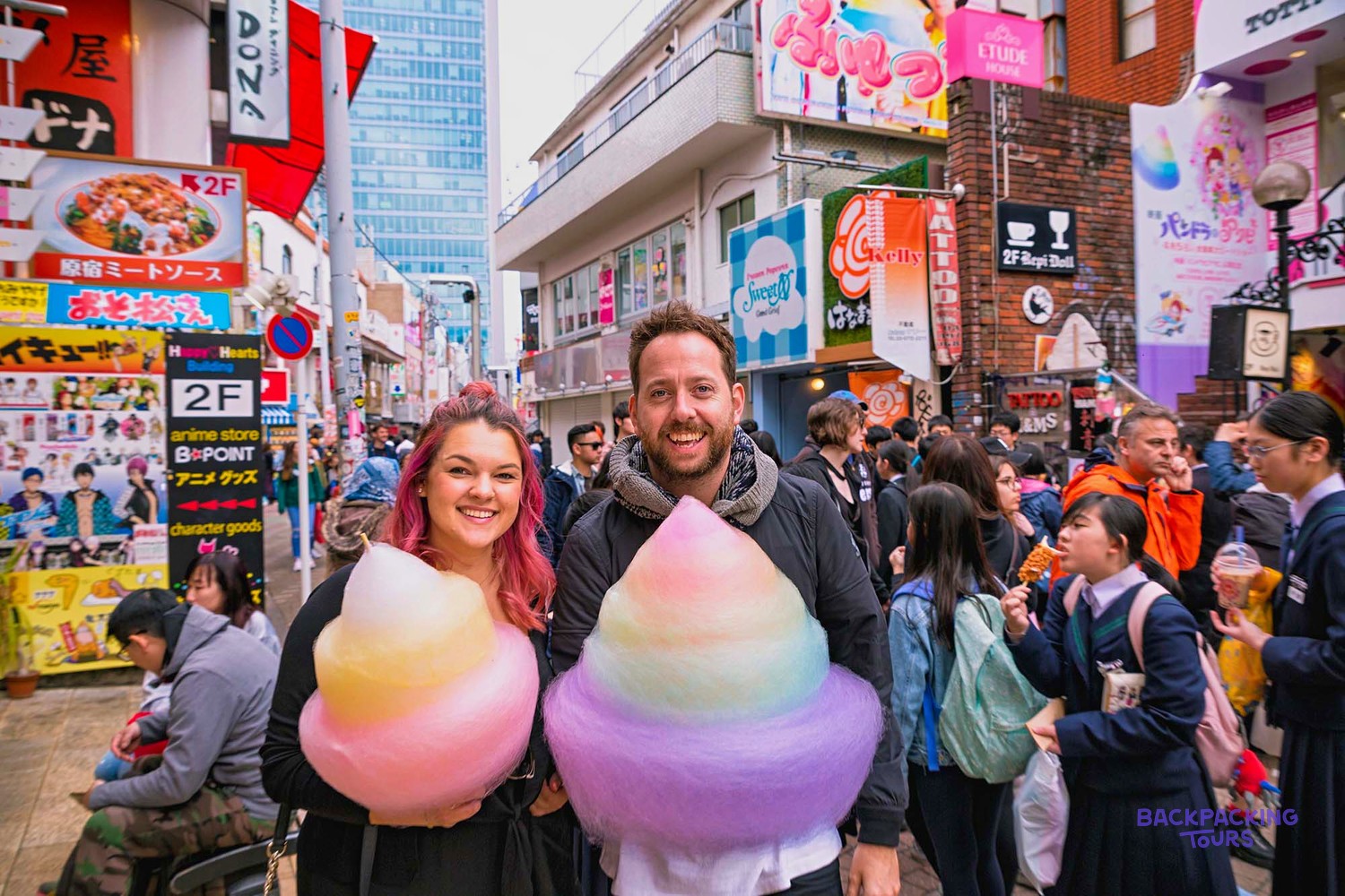 Couple holding giant rainbow candy floss on Harajuku's Takeshita Street