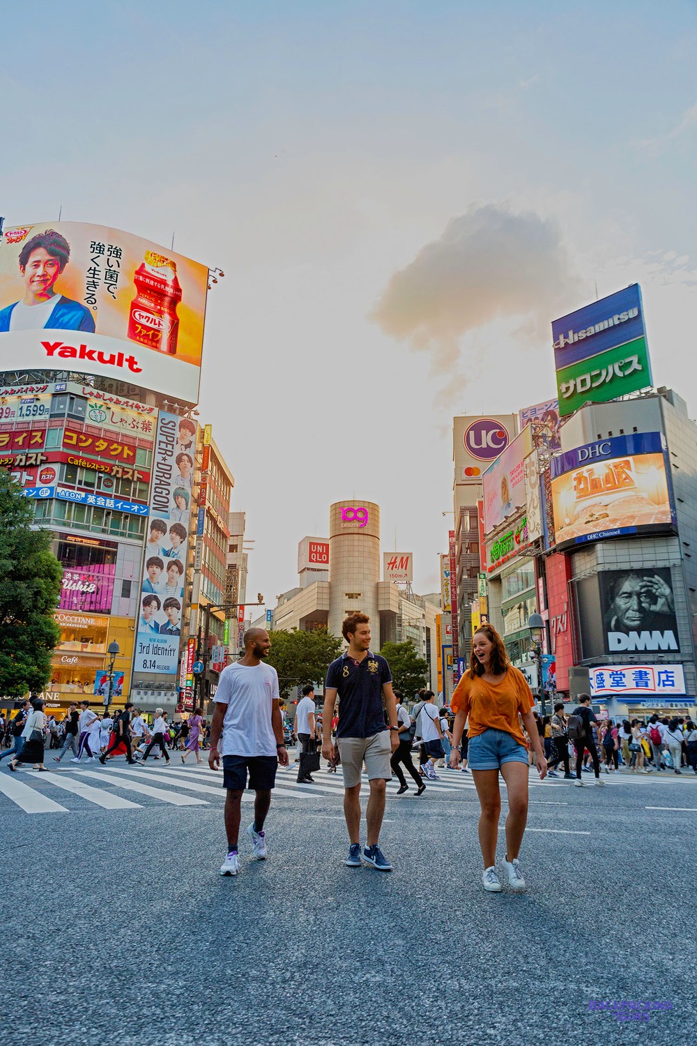 Travellers walking across the world's busiest intersection in Shibuya