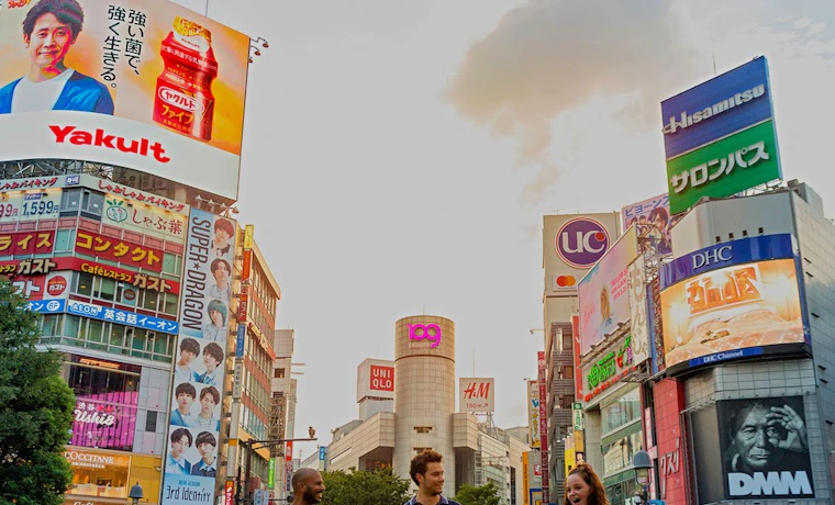 Travellers walking across the world's busiest intersection in Shibuya