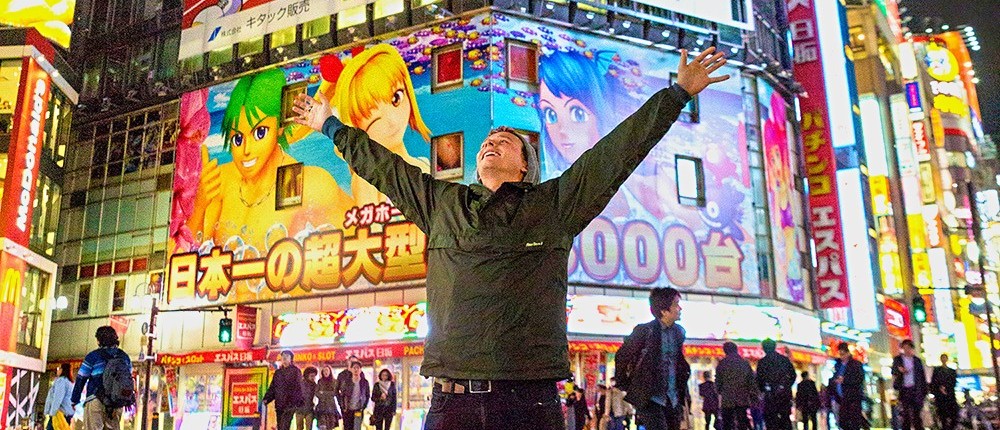 Neon billboards towering over the crowds in Tokyo's Akihabara Electric Town
