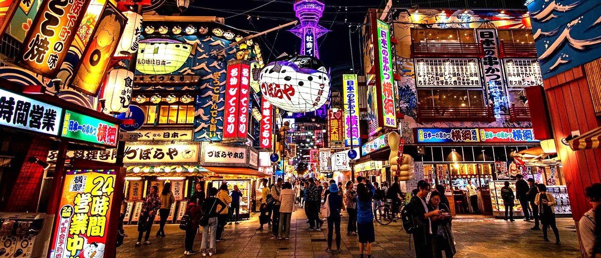 Neon signs and lanterns lighting up the retro Shinsekai district of Osaka
