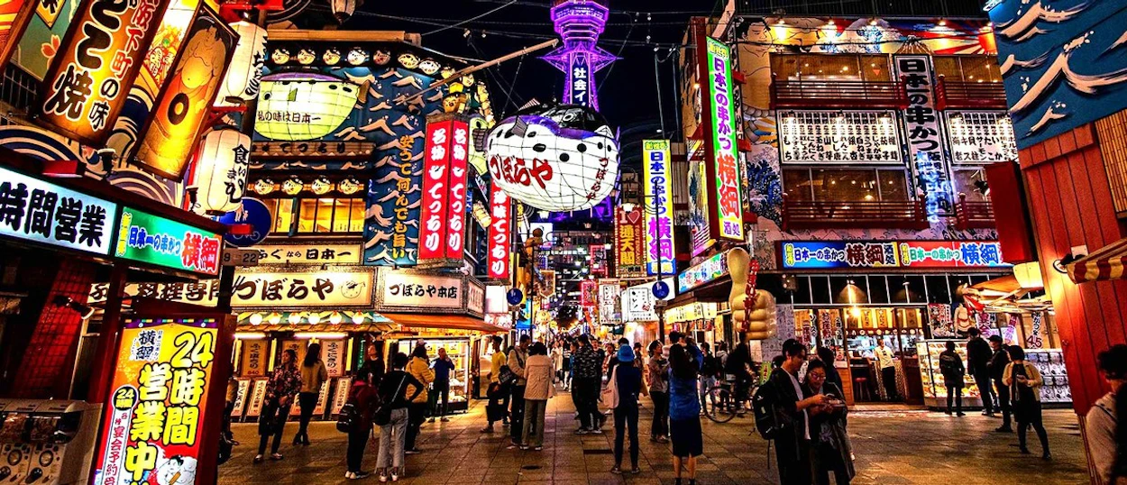 Neon signs and lanterns lighting up the retro Shinsekai district of Osaka
