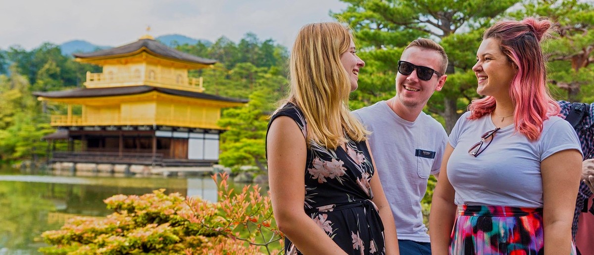Group of travellers in front of the Golden Pavilion in Kyoto