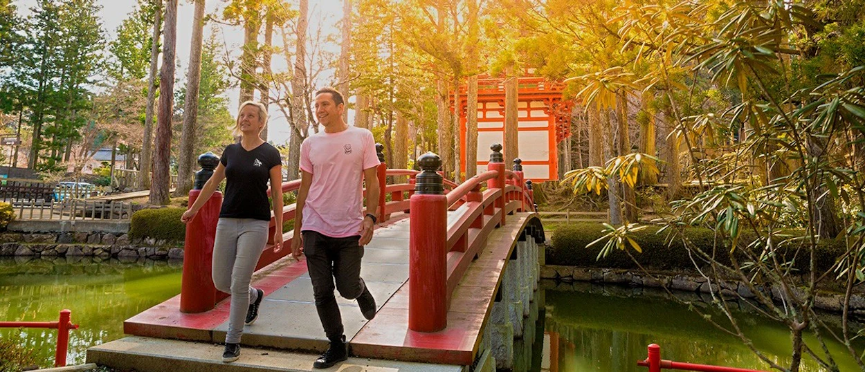 Travellers crossing the red bridge into Koyasan