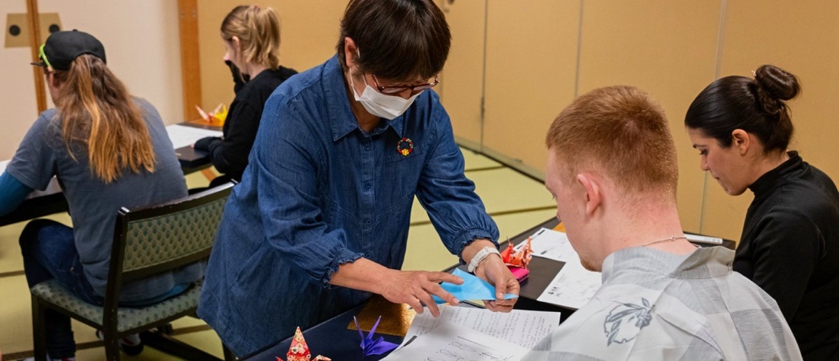 Local artisan teaching a traveller the art of origami in Nagano