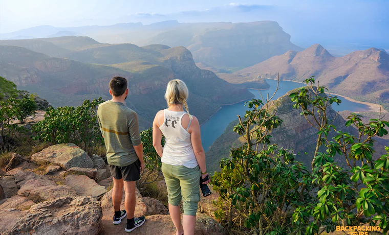 Two travelers admire the breathtaking views of Blyde River Canyon and its winding river.