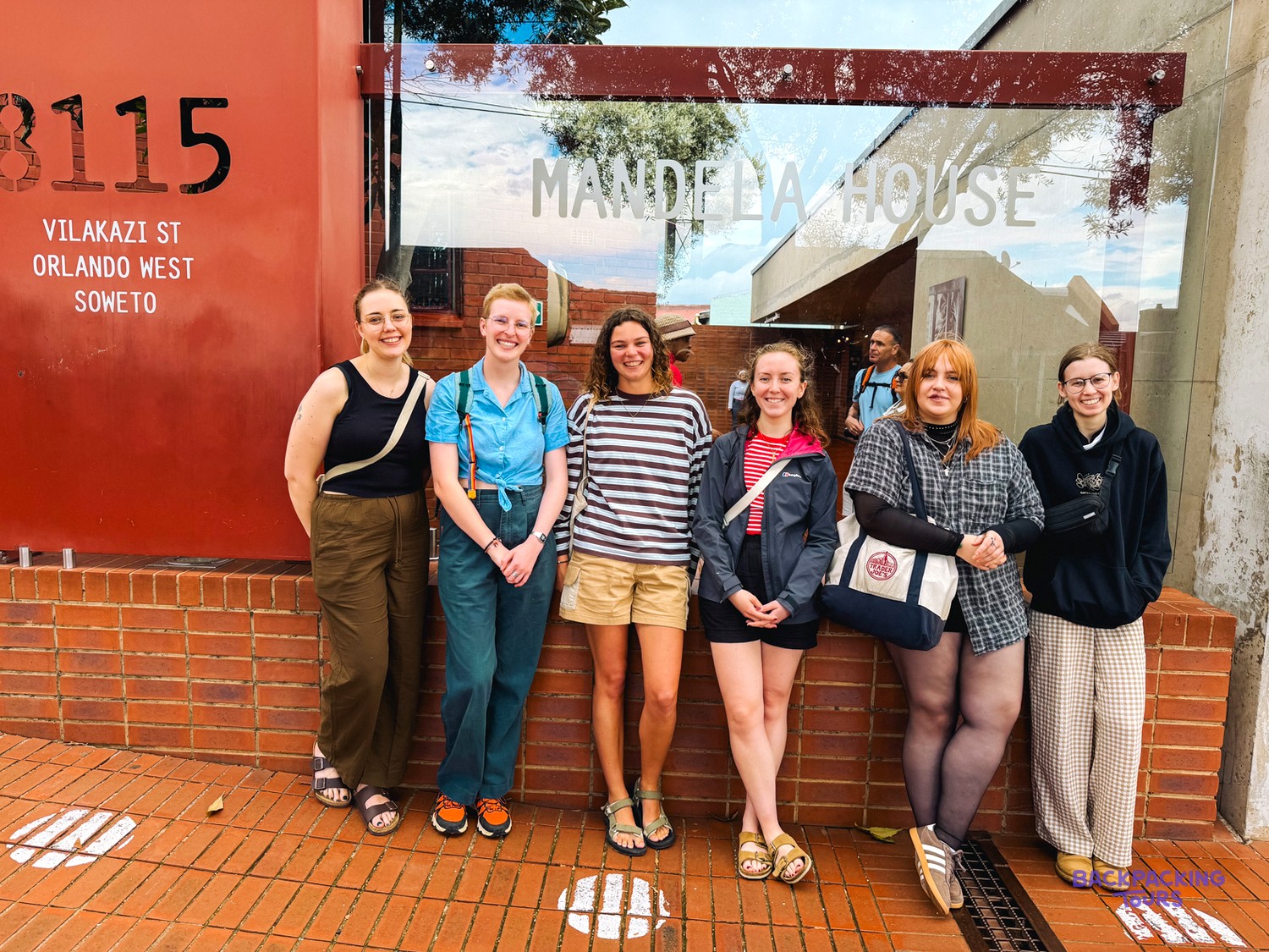 Group of travellers standing outside Mandela House on Vilakazi Street in Soweto