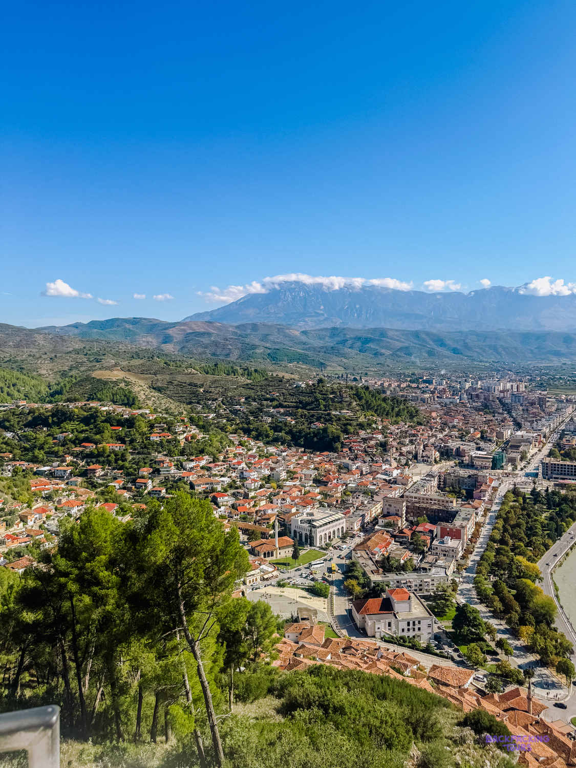 View from the castle hill over Berat's red roofs and the valley towards distant mountains