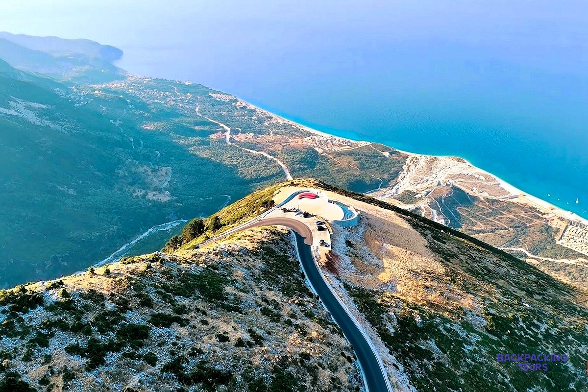 The Llogara Pass road winding over a mountain ridge above the turquoise Ionian coast