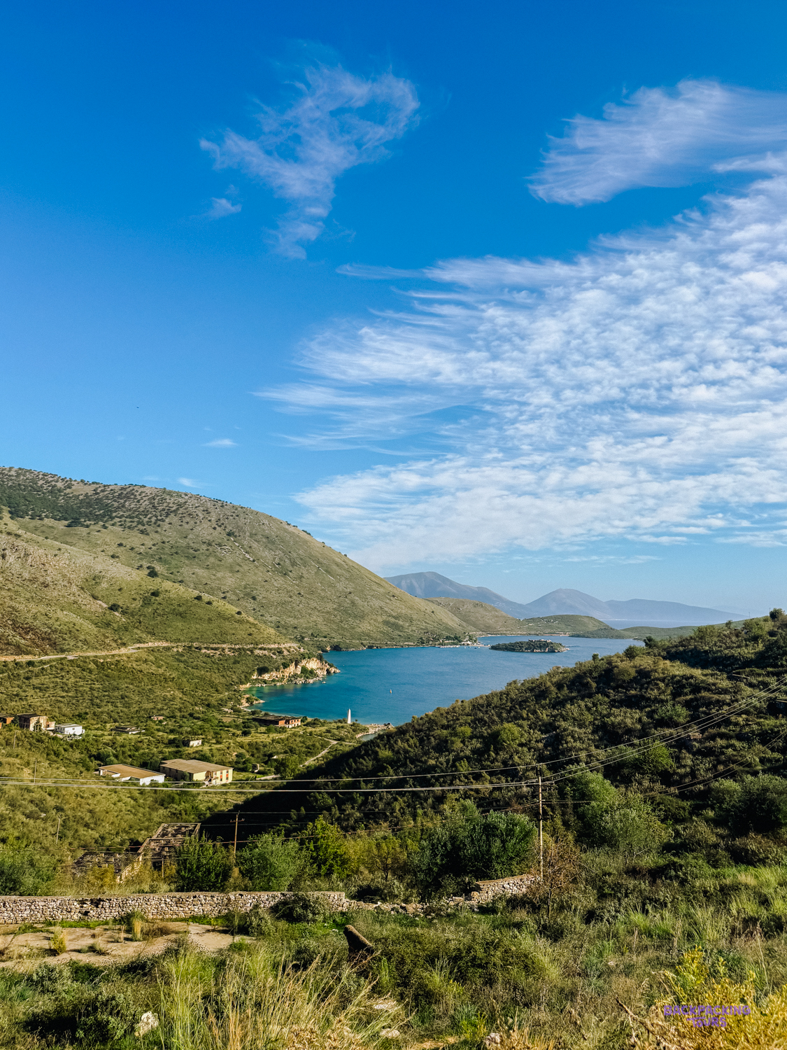The bay of Porto Palermo and its small island seen from the green hills above the coast