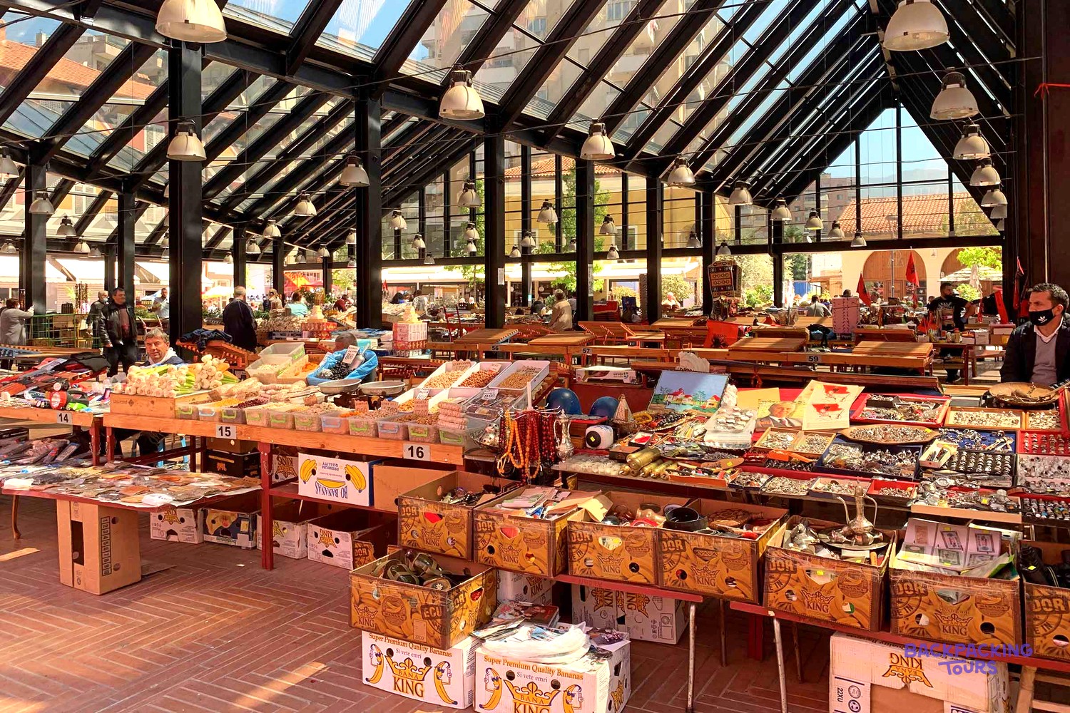 Tables of souvenirs, crafts and local produce inside the covered New Bazaar in Tirana