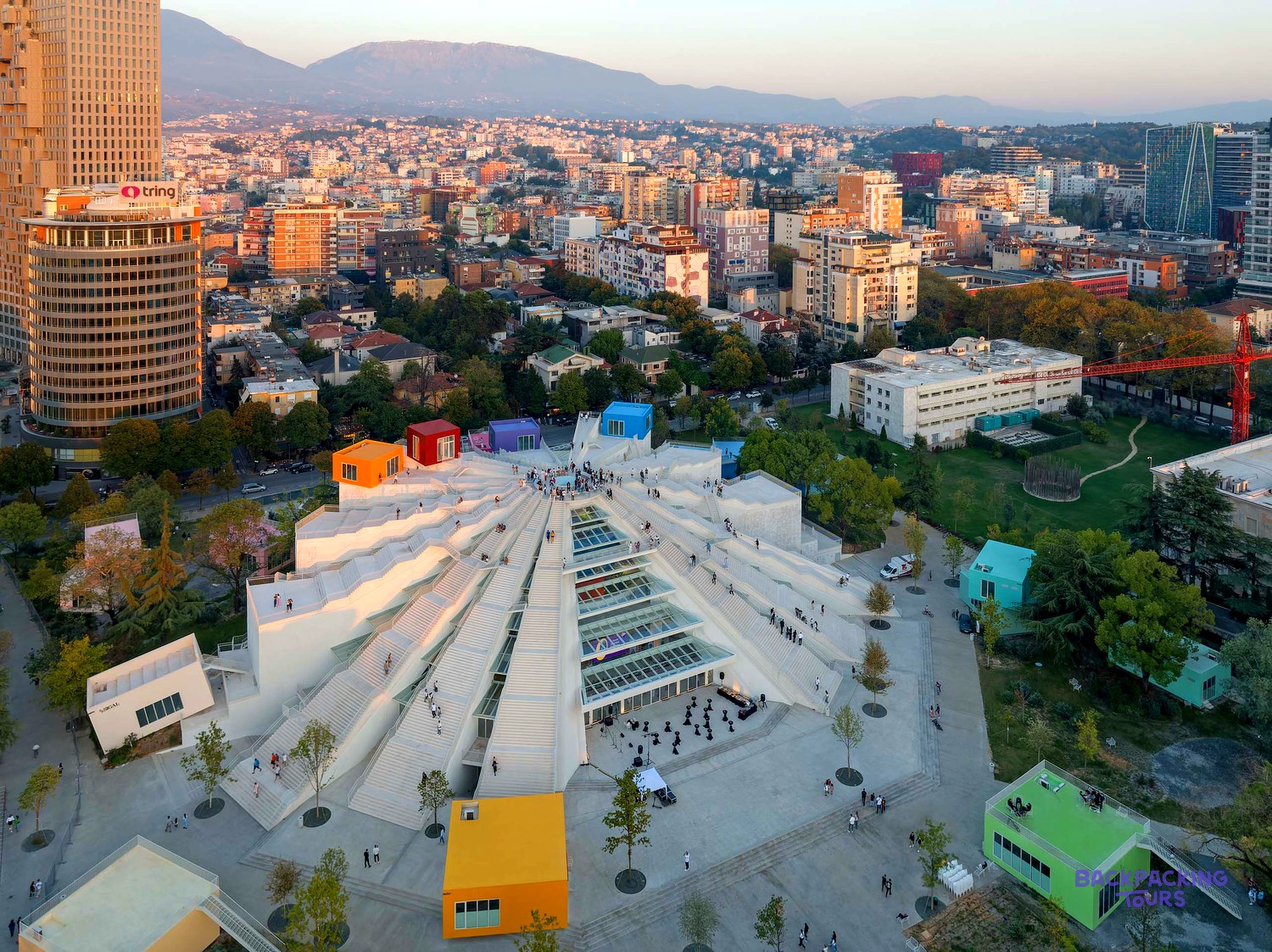 The renovated Pyramid of Tirana with its white terraced steps and colourful cubes, seen from above