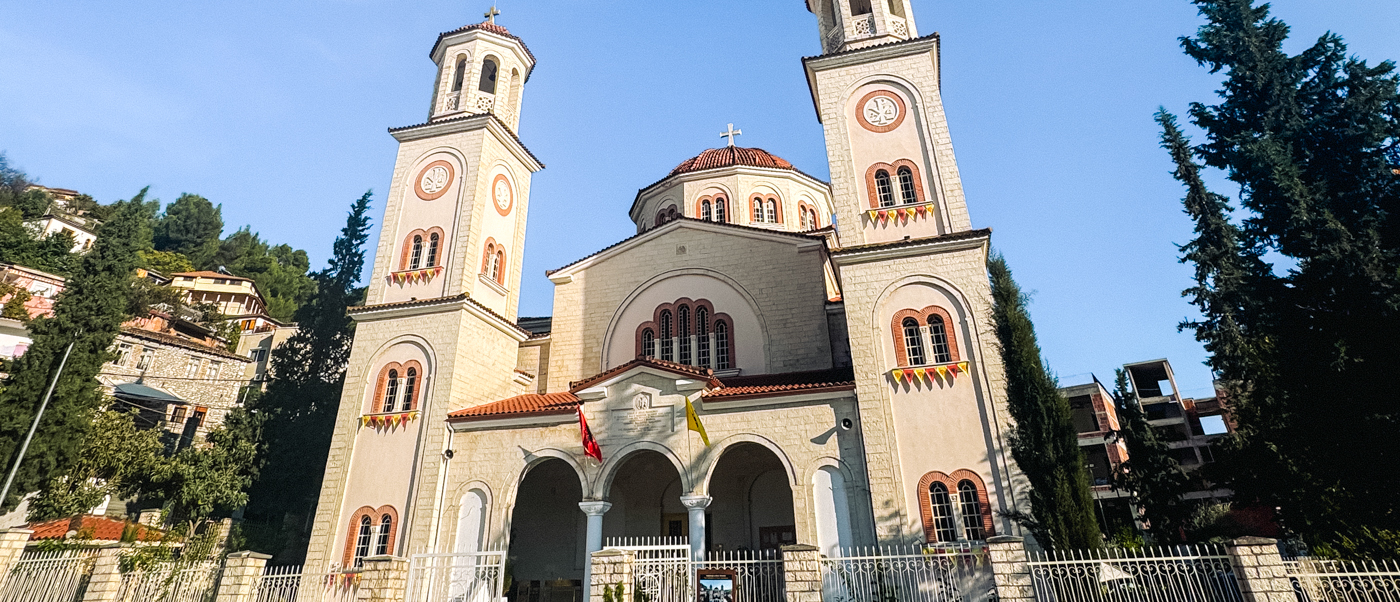 The twin bell towers of St Demetrius Orthodox Cathedral in Berat under a clear blue sky