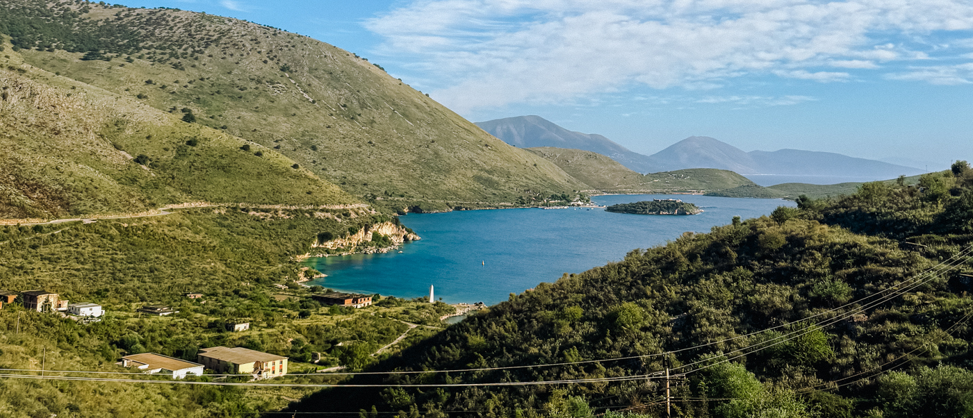The bay of Porto Palermo and its small island seen from the green hills above the coast