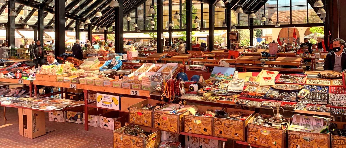 Tables of souvenirs, crafts and local produce inside the covered New Bazaar in Tirana