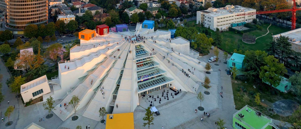The renovated Pyramid of Tirana with its white terraced steps and colourful cubes, seen from above