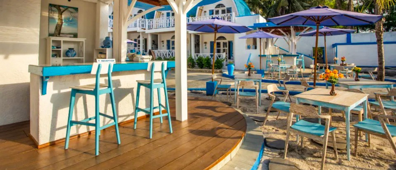 Open-air beachside café with turquoise chairs on Gili Trawangan