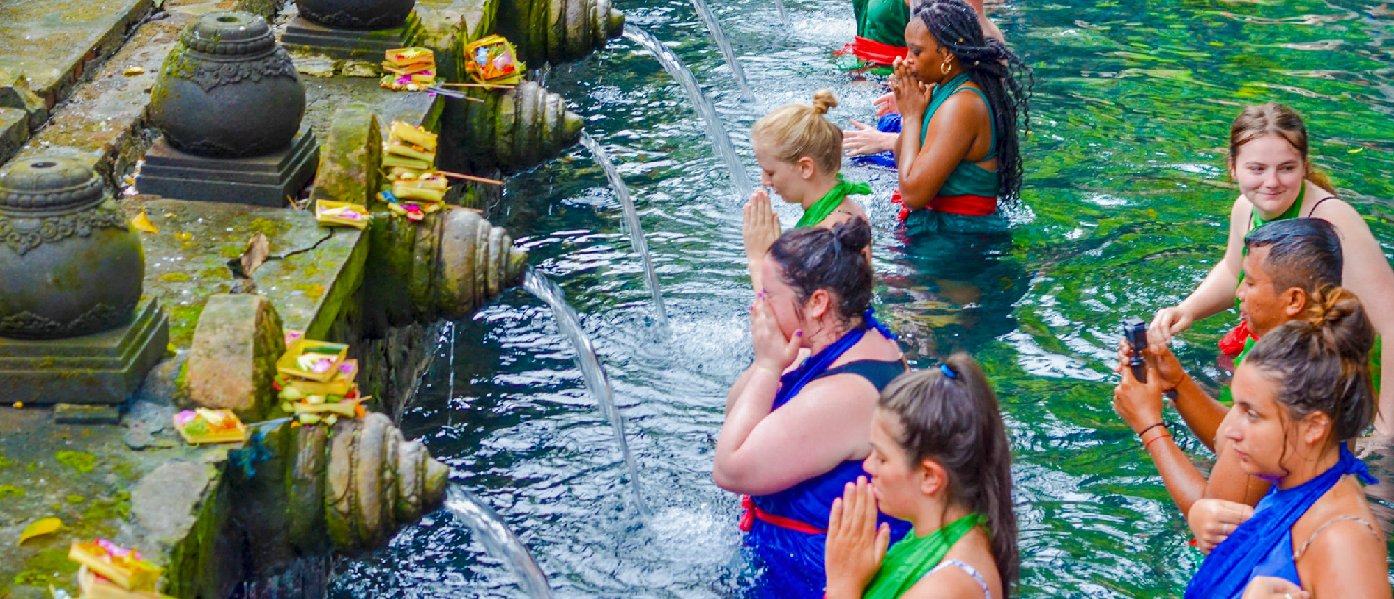 Backpacking group bathing in the sacred waters at Pura Tirta Empul