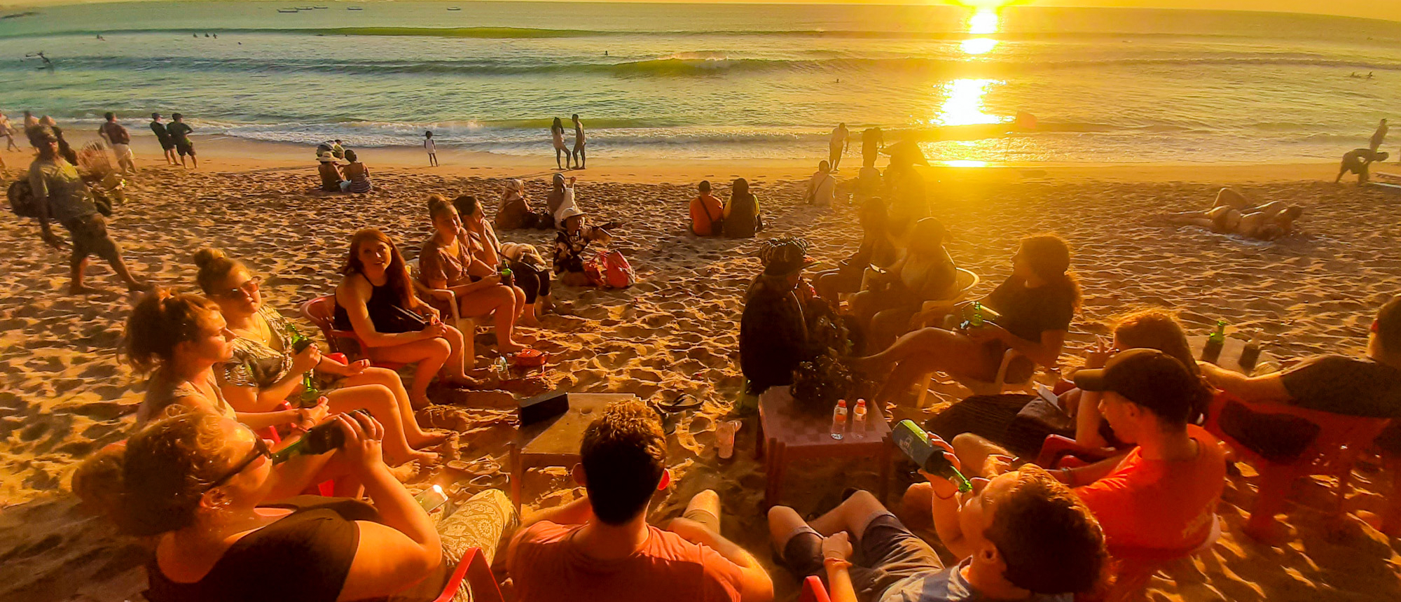 Friends watching sunset on a Balinese beach