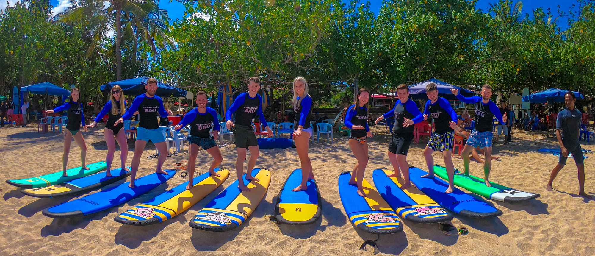 Surfboards lined up on the sand for a surf lesson in Canggu