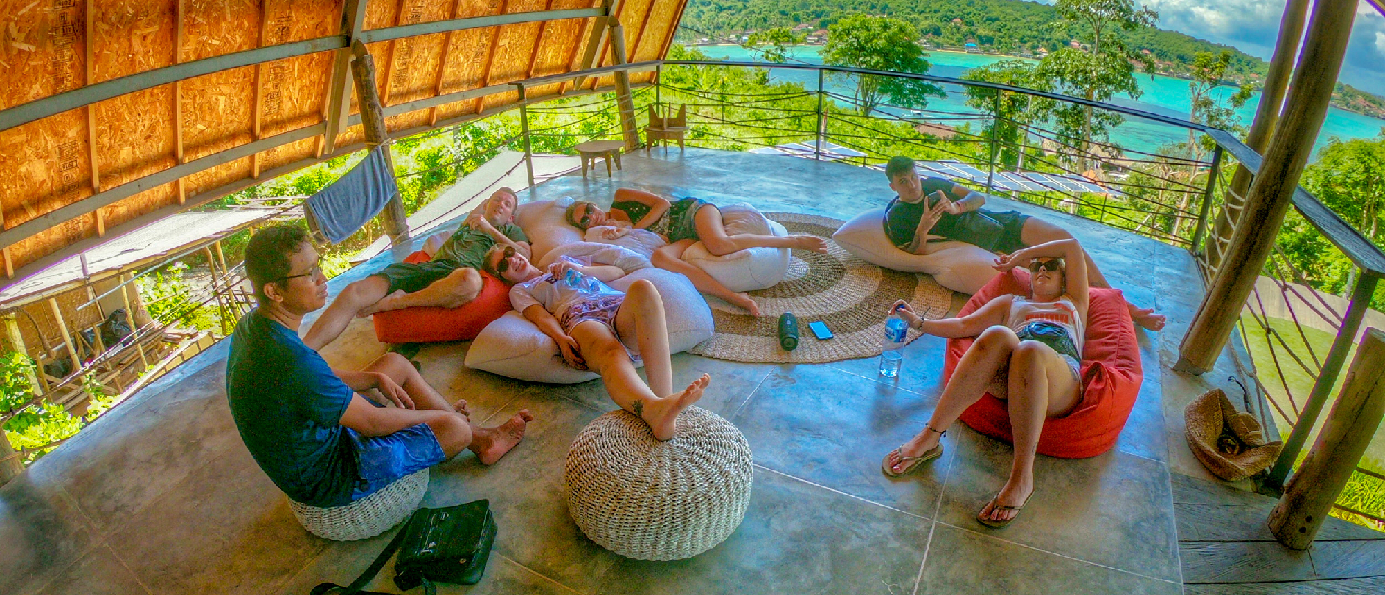 Group relaxing in round wicker lounge chairs at the hotel in Nusa Lembongan
