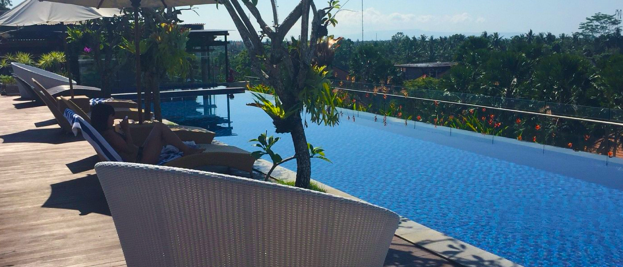 Evening resort pool surrounded by palm trees in Bali