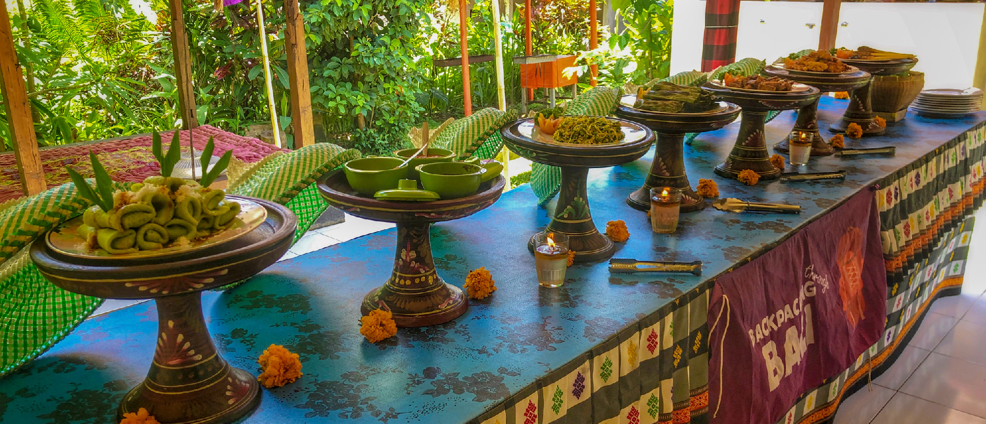 Traditional Balinese offerings arranged on a long table in Ubud