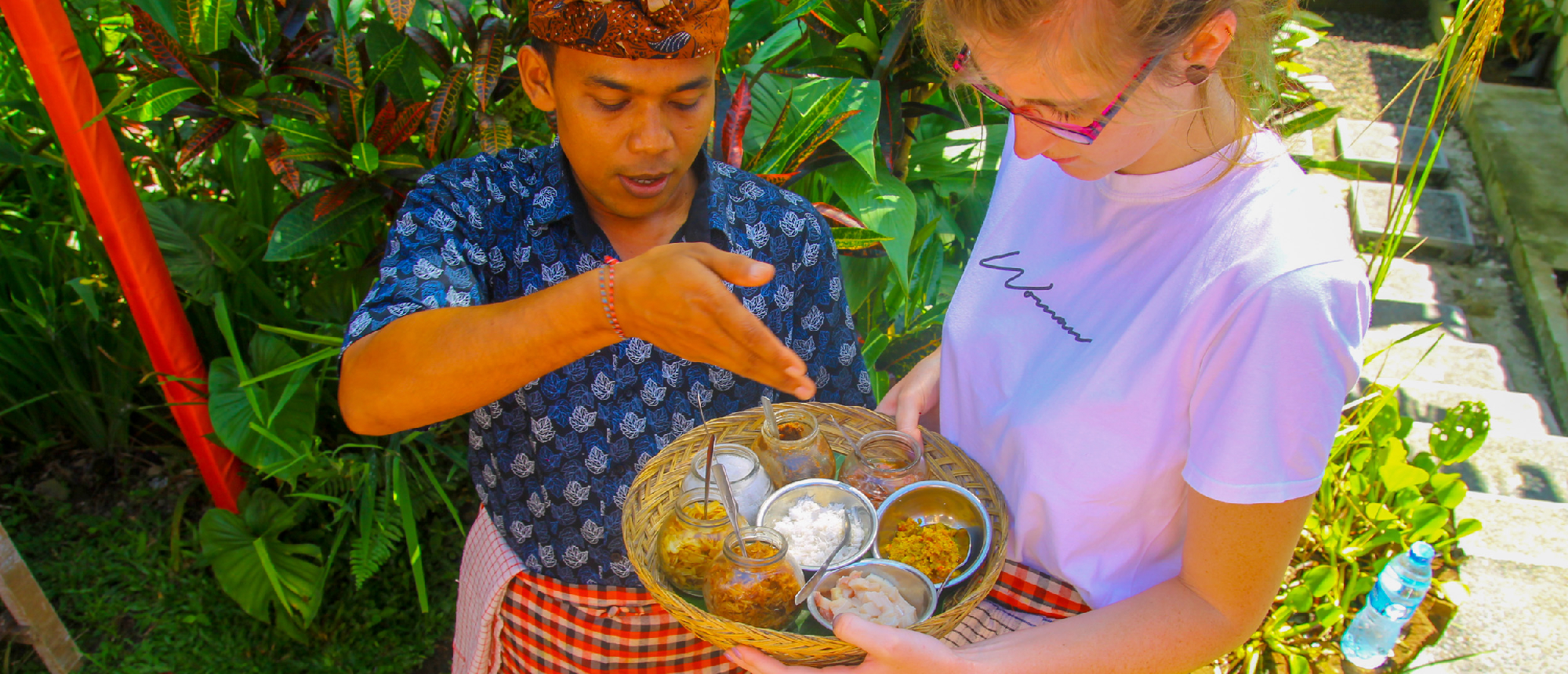 Balinese man serving food in traditional setting in Ubud